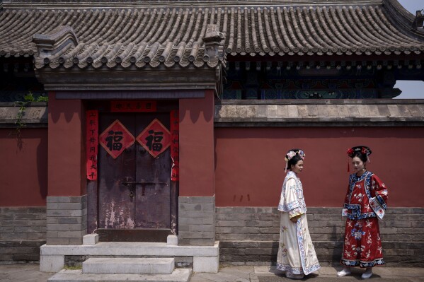 Chinese women dressed in Qing Dynasty attire at the Forbidden city in Beijing, China, Sunday, July 21, 2024. (AP Photo/Vincent Thian)