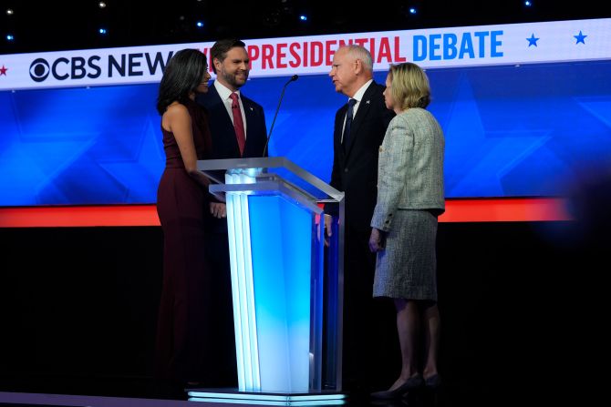 The Walzes talk briefly with Vance and his wife, Usha, immediately after the debate.