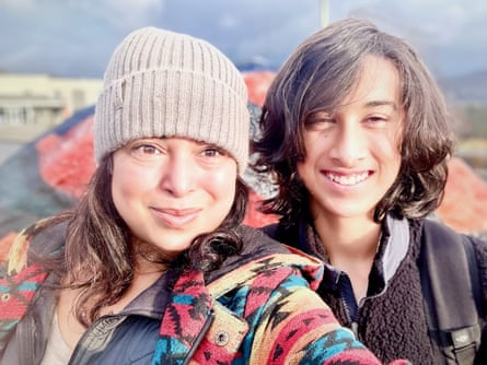 a women and boy smiling at camera outside