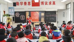 A volunteer lawyer is explaining the Patriotic Education Law of the People's Republic of China to primary school students in Huai'an, China, on December 28, 2023. (Photo by Costfoto/NurPhoto via Getty Images)