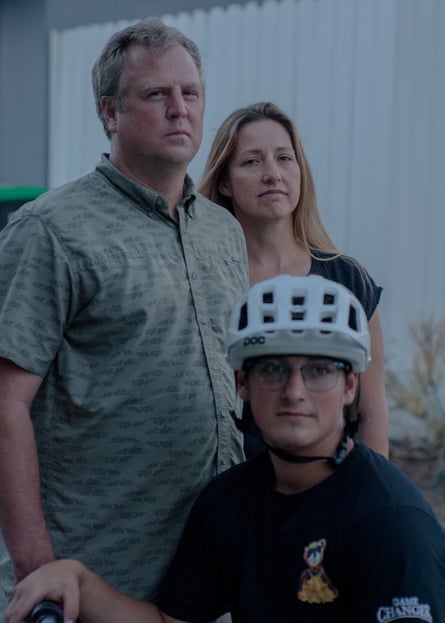 two adults and a child in a bike helmet