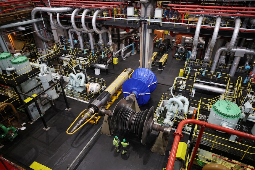 Shot inside the cavernous Ratcliffe coal plant looking down over machinery and workers