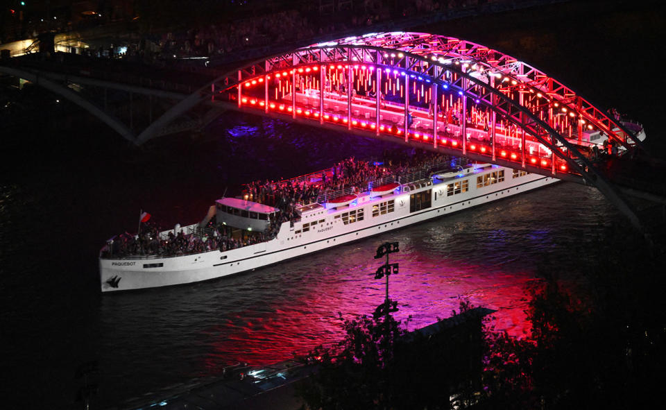 A boat with the French delegation, pictured here passing under the passerelle Debilly footbridge.