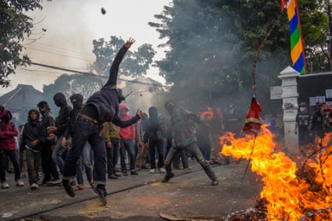 Demonstrators throw stones at the police outside the parliament in Bandung, West Java on 22 August in Indonesia.