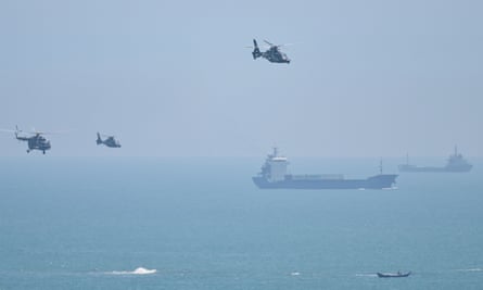 Chinese military helicopters fly past Pingtan island, one of mainland China’s closest point from Taiwan, in Fujian province ahead of massive military drills off Taiwan following US House Speaker Nancy Pelosi’s visit to the self-ruled island