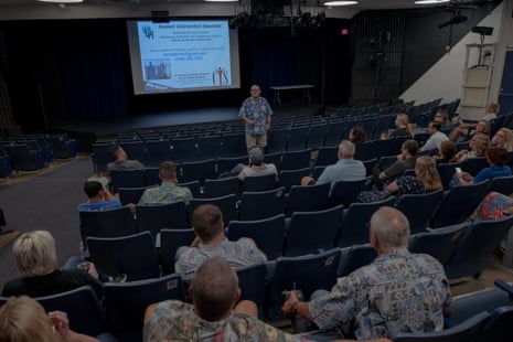 Man gives presentation to crowd of adults