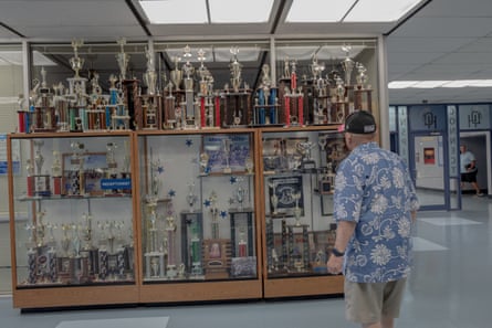 Man looks into large trophy case.