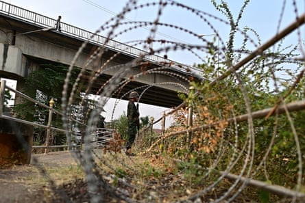 A Thai soldier stands guard in Mae Sot near the border with Myanmar, in April. The area has descended into chaos in the wake of the coup in 2021 by Myanmar’s junta.