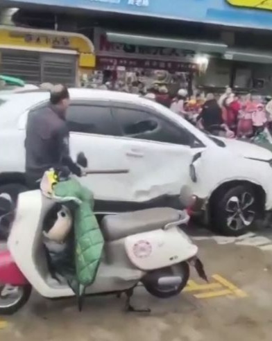 Angry bystanders appeared to pull the man from his car and beat him at the scene