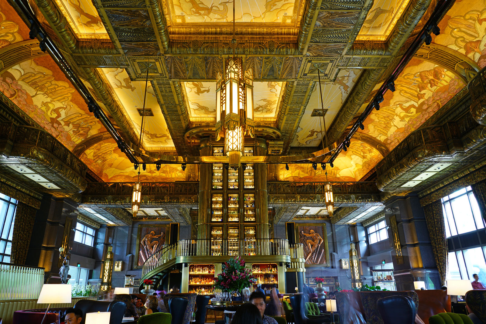 A large art deco room with a bar. 