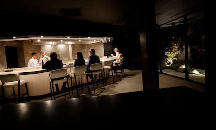 Chef Masayuki Otaka, second from left, talks to customers at Japanese restaurant Mabo, which...