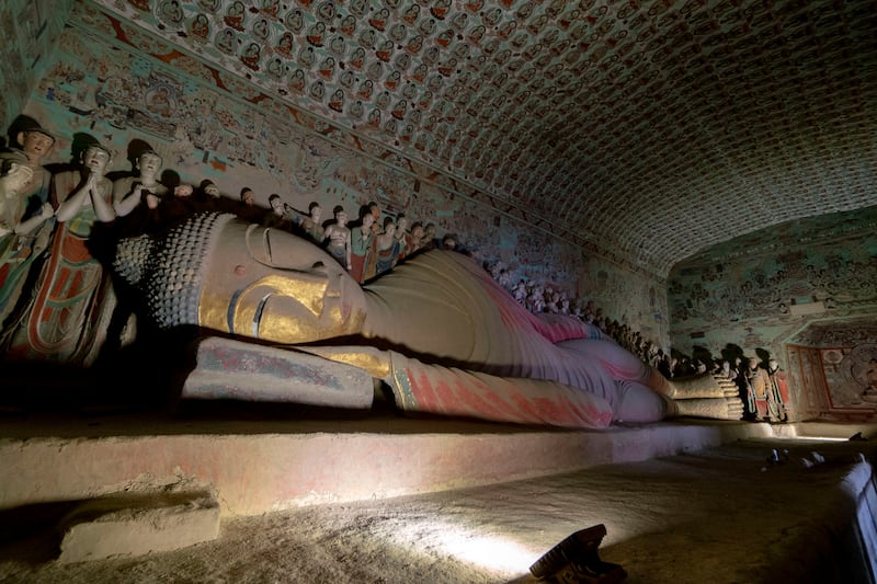 Statue of the final Nirvana of the Buddha in the Mogao Caves. Photograph: Zhang Peng/LightRocket via Getty 