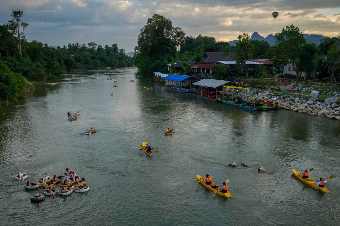 Foreign tourists float on tubes in a river in Vang Vieng, Laos, on November 19, 2024.