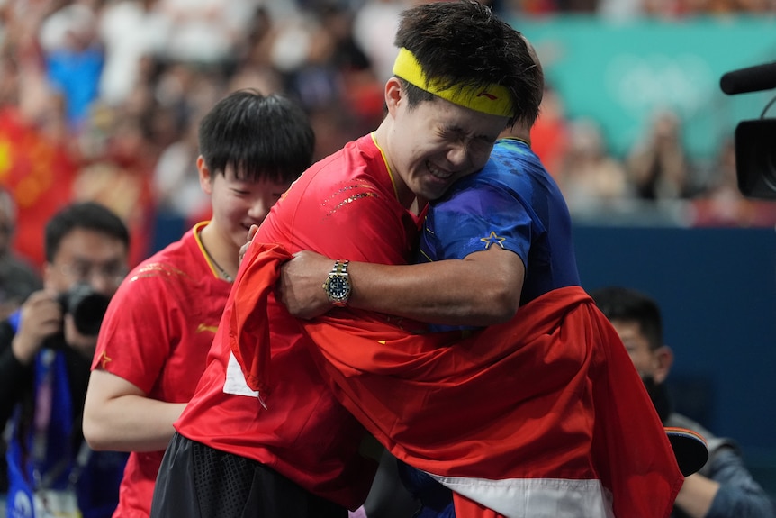 Wang Chuqin celebrates after winning the gold medal