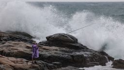 A man goes fishing near high waves as Super Typhoon Kong-rey approaches in Keelung in the northeastern part of Taiwan on October 29, 2024.