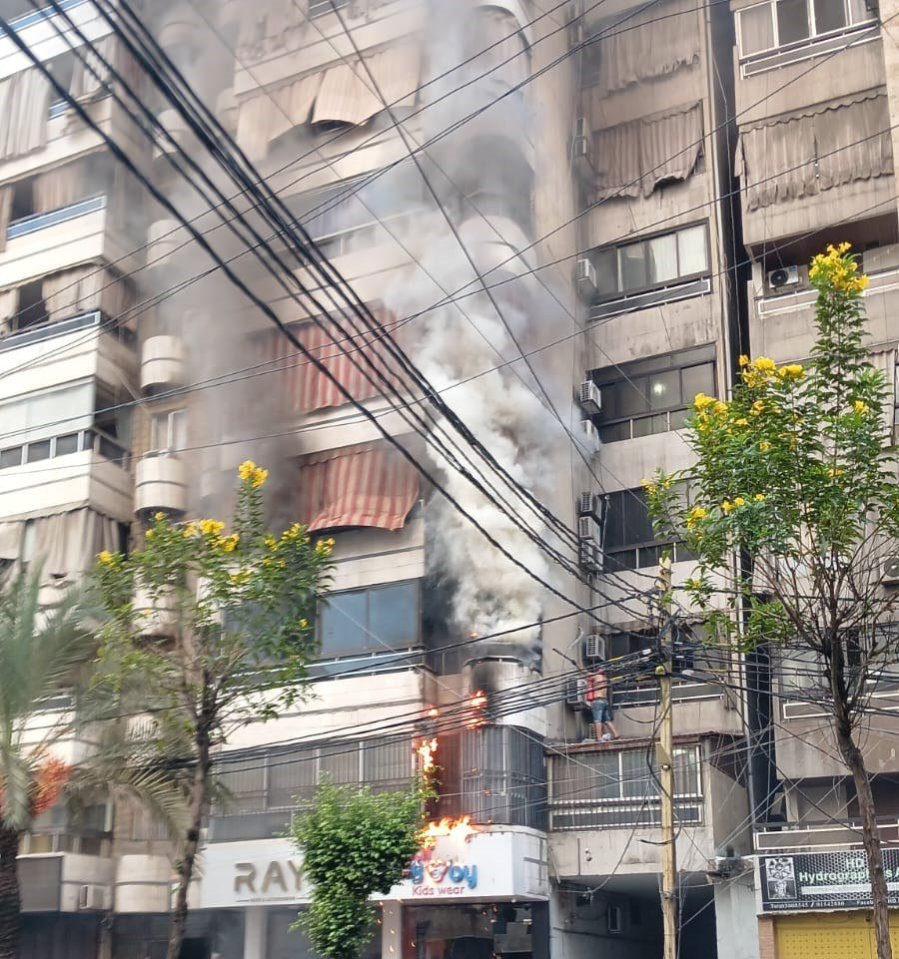 A building caught fire after the second wave of blasts