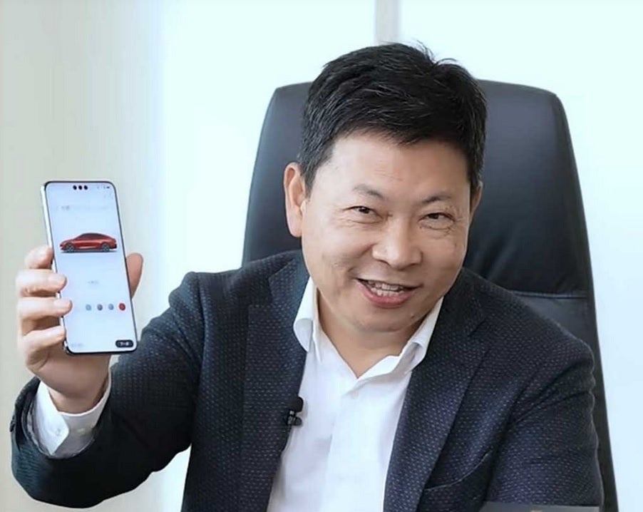 Huawei's Yu shows off the front of the Mate 70 Pro+ with its unique triple cutout camera.