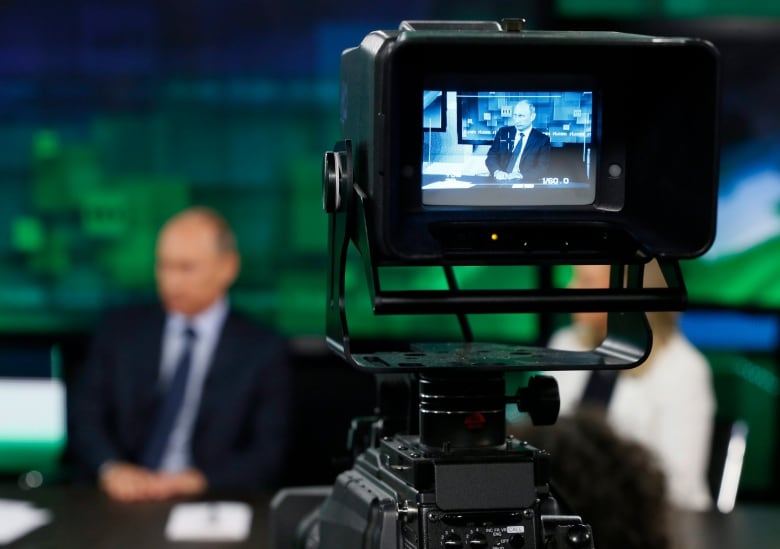 Russian President Vladimir Putin is shown on the screen of a camera viewfinder at the new headquarters of the Russia Today television channel in Moscow, Russia on Tuesday, June 11, 2013. 