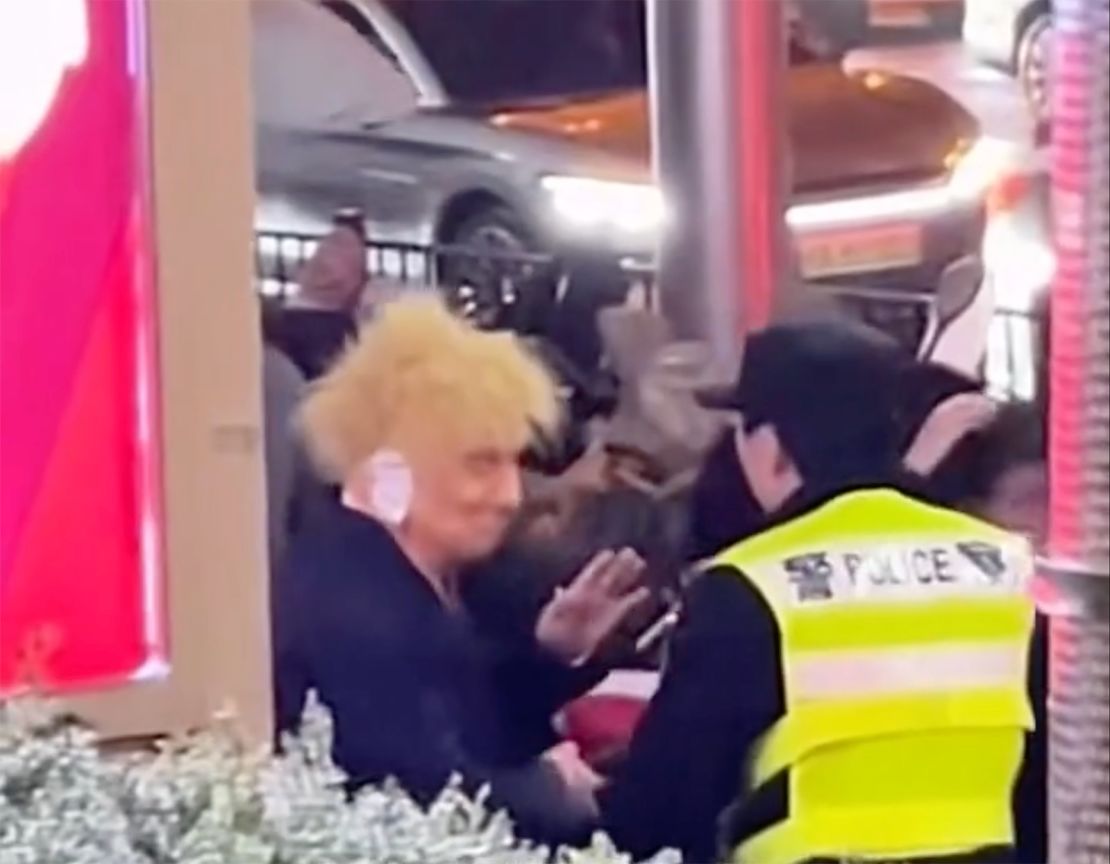 A reveler dressed up as Republican presidential candidate Donald Trump is taken away by police in Shanghai during Halloween celebrations on October 26, 2024.