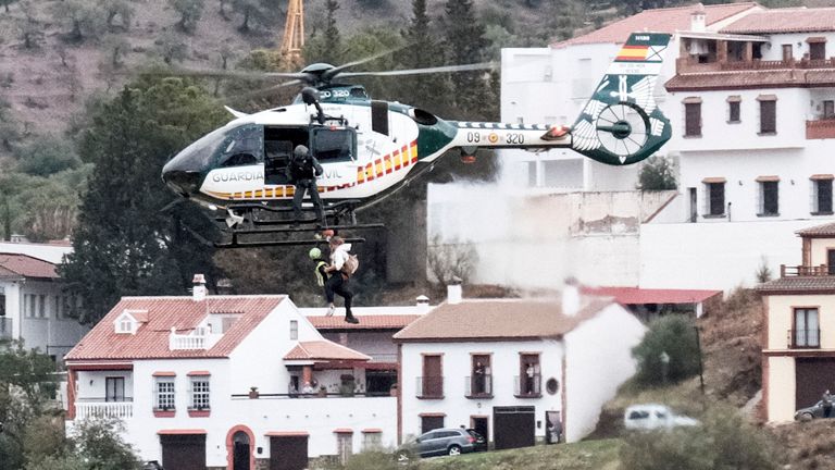 Emergency teams rescue a person who was stranded by the water in a Guardia Civil helicopter, after the floods preceded by heavy rains that caused the overflow of the river in the town of Alora, Malaga, Spain, Tuesday, Oct. 29, 2024. (AP Photo/Gregorio Marrero)