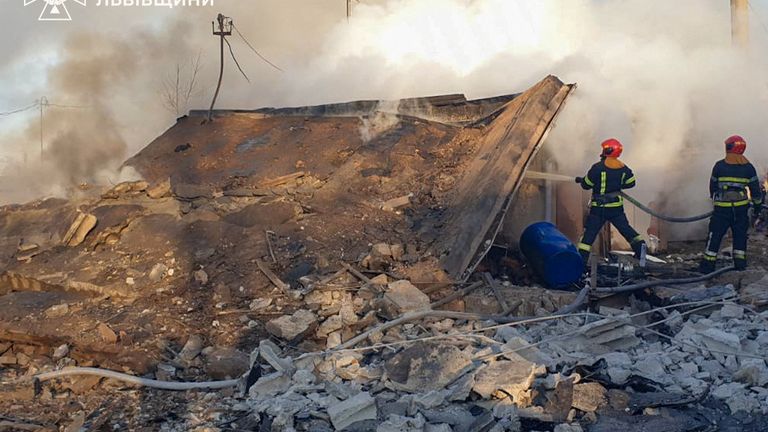 Firefighters work at the site of a residential area hit by a Russian missile strike in the Lviv region of Ukraine. Pic: Reuters 