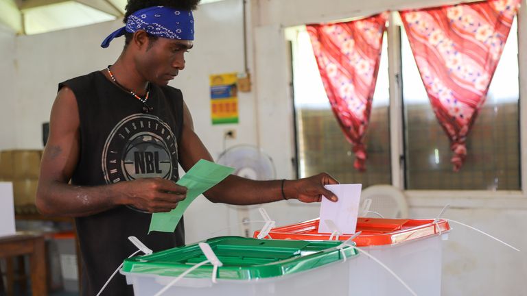 A man casts his vote during the Solomon Islands elections. Pic: AP Photo/Charley Piringi