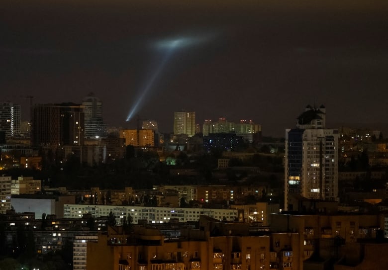 Ukrainian service personnel use searchlights as they search for drones in the sky over the city during a Russian drone strike, amid Russia's attack on Ukraine, in Kyiv, Ukraine October 25, 2024. 